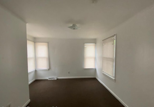 306 Church St, Poughkeepsie, NY 12601 - empty room featuring dark carpet and baseboards