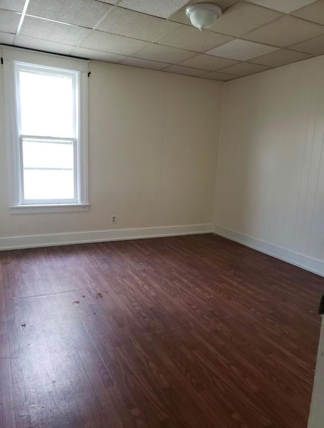 306 Church St, Poughkeepsie, NY 12601 - unfurnished room featuring dark wood-type flooring, a paneled ceiling, and plenty of natural light