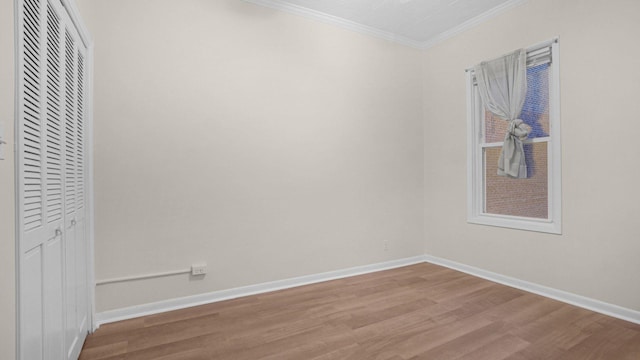 868 Morris Park Ave, Bronx, NY 10462 - unfurnished bedroom featuring wood finished floors, crown molding, and a closet