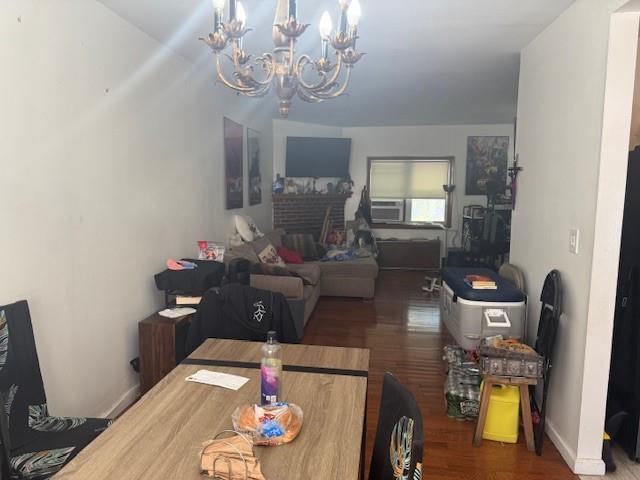 33-42 70th St, Jackson Heights, NY 11372 - dining room featuring a chandelier, wood finished floors, and a fireplace