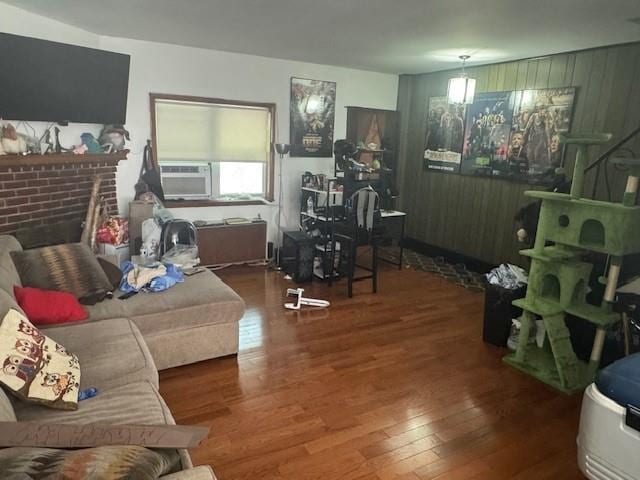 33-42 70th St, Jackson Heights, NY 11372 - living room featuring wood finished floors, cooling unit, and a brick fireplace