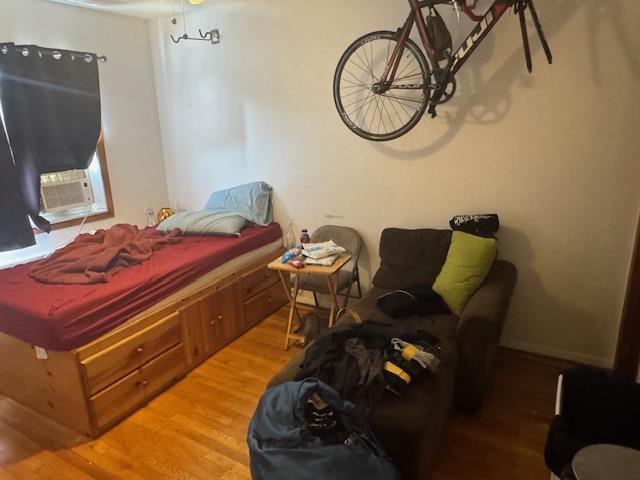 33-42 70th St, Jackson Heights, NY 11372 - bedroom with wood finished floors and cooling unit