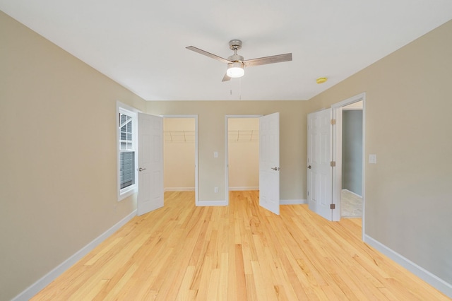 159 Mohawk St, Ronkonkoma, NY 11779 - unfurnished bedroom featuring light wood-type flooring, ceiling fan, and a walk in closet