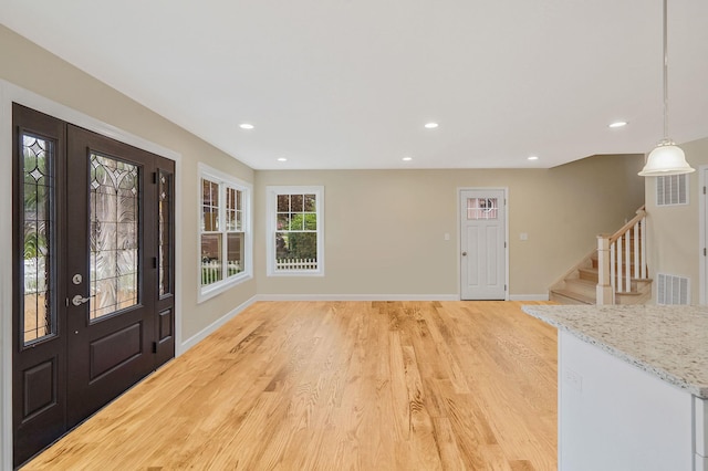 159 Mohawk St, Ronkonkoma, NY 11779 - foyer with light wood finished floors, recessed lighting, and stairway