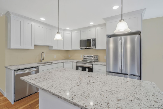 159 Mohawk St, Ronkonkoma, NY 11779 - kitchen with appliances with stainless steel finishes, light wood-style flooring, white cabinets, light stone countertops, and recessed lighting