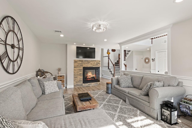 62 Hamlet Dr, Commack, NY 11725 - living room with wood finished floors, a fireplace, stairway, and recessed lighting