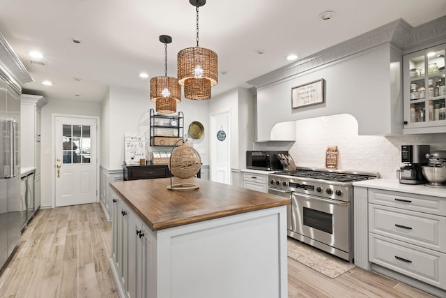 62 Hamlet Dr, Commack, NY 11725 - kitchen with stainless steel appliances, butcher block counters, a center island, recessed lighting, and decorative backsplash