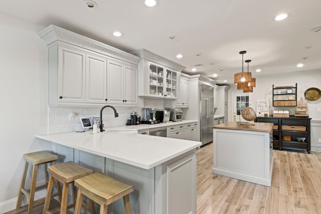 62 Hamlet Dr, Commack, NY 11725 - kitchen with stainless steel appliances, a center island, backsplash, light wood-style floors, and recessed lighting