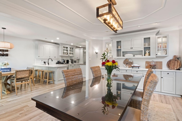 62 Hamlet Dr, Commack, NY 11725 - dining area featuring light wood-style flooring, recessed lighting, ornamental molding, and a tray ceiling