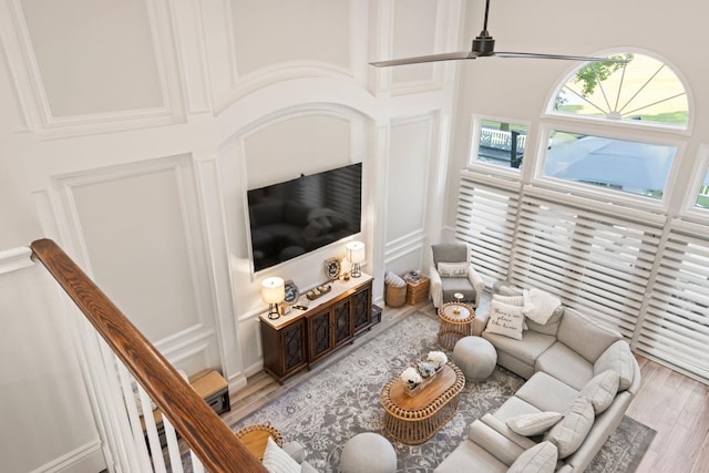 62 Hamlet Dr, Commack, NY 11725 - living room with light wood-style flooring, a high ceiling, and a ceiling fan