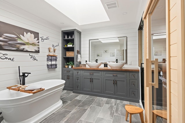 62 Hamlet Dr, Commack, NY 11725 - full bathroom with double vanity, wooden walls, a freestanding bath, and a shower