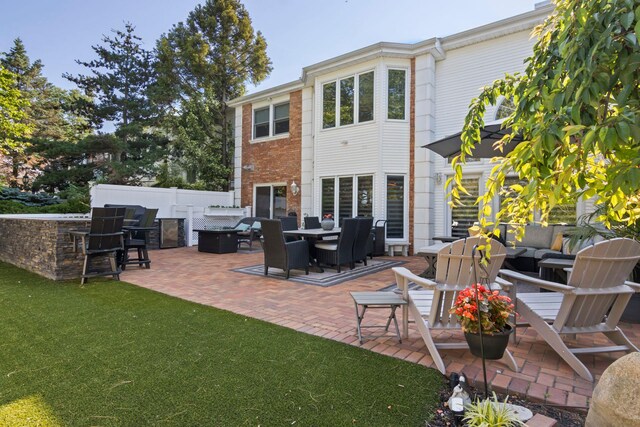 62 Hamlet Dr, Commack, NY 11725 - back of property with a patio, an outdoor living space with a fire pit, and brick siding