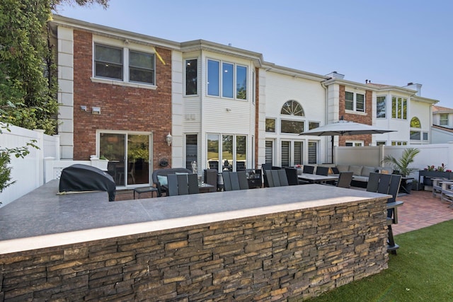 62 Hamlet Dr, Commack, NY 11725 - rear view of house with a patio, outdoor lounge area, and brick siding