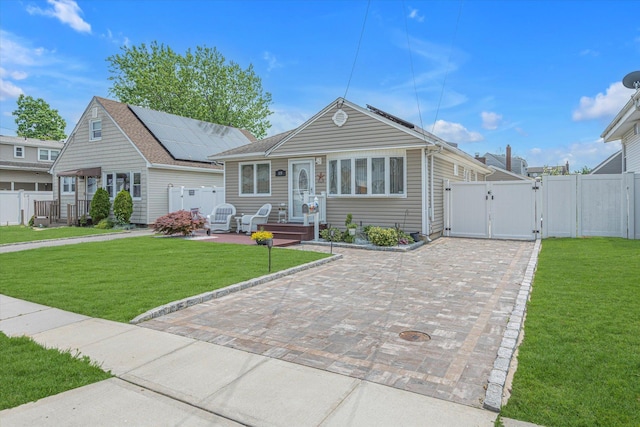 115 W Granada Ave, Lindenhurst, NY 11757 - view of front of home with a gate and solar panels