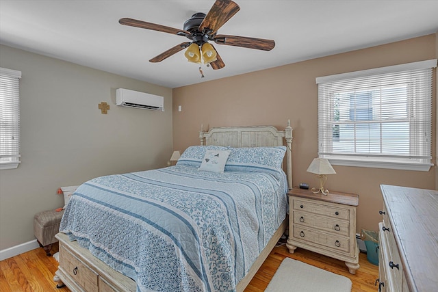 115 W Granada Ave, Lindenhurst, NY 11757 - bedroom with an AC wall unit, multiple windows, light wood finished floors, and ceiling fan