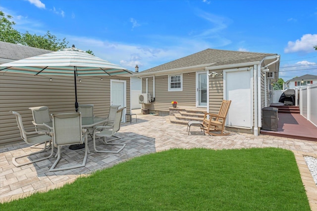115 W Granada Ave, Lindenhurst, NY 11757 - back of house featuring roof with shingles, a patio area, and outdoor dining space