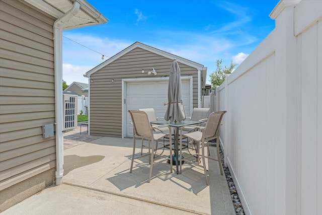 115 W Granada Ave, Lindenhurst, NY 11757 - view of patio / terrace featuring outdoor dining area, an outbuilding, and a garage