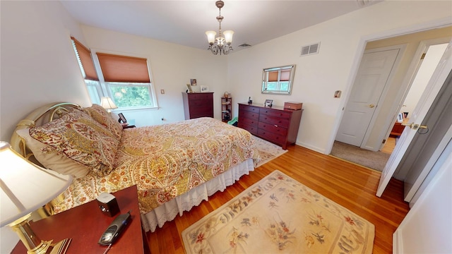 223 146th Pl, Whitestone, NY 11357 - bedroom featuring wood finished floors and a chandelier