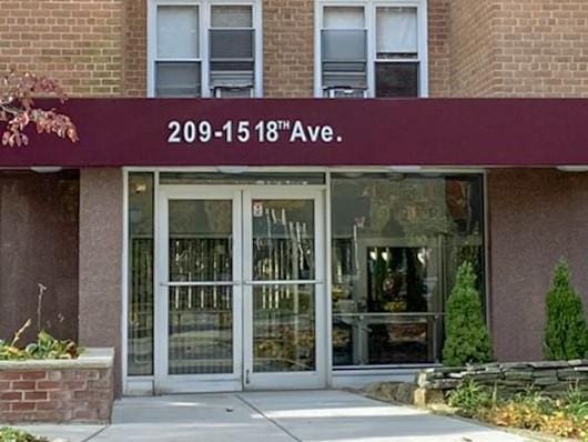 209-15 18th Ave Unit 2A, Bayside, NY 11360 - view of exterior entry featuring brick siding and stucco siding