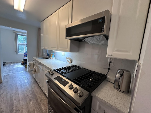 209-15 18th Ave Unit 2A, Bayside, NY 11360 - kitchen with stainless steel appliances, white cabinets, wood finished floors, and light countertops