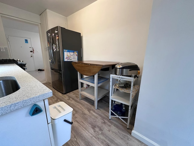 209-15 18th Ave Unit 2A, Bayside, NY 11360 - kitchen featuring freestanding refrigerator, light wood-style floors, and white cabinets
