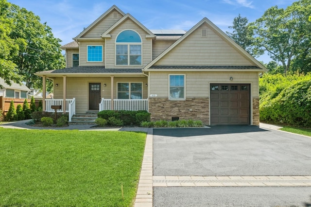 413 Robyn Pl, East Meadow, NY 11554 - craftsman inspired home featuring covered porch, a front lawn, an attached garage, driveway, and roof mounted solar panels