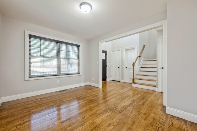 413 Robyn Pl, East Meadow, NY 11554 - empty room with wood finished floors and stairway