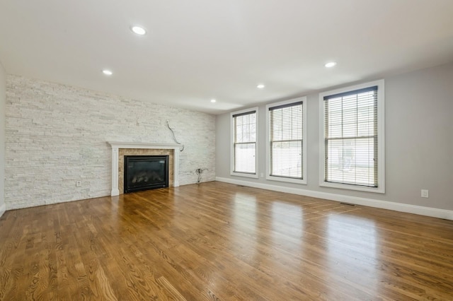 413 Robyn Pl, East Meadow, NY 11554 - unfurnished living room with a glass covered fireplace, wood finished floors, and recessed lighting