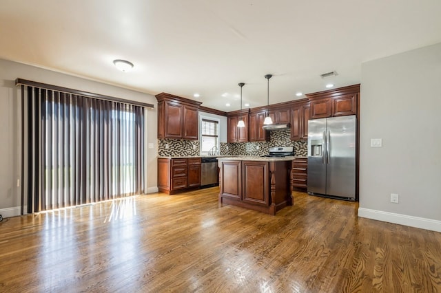 413 Robyn Pl, East Meadow, NY 11554 - kitchen with stainless steel appliances, decorative backsplash, light countertops, decorative light fixtures, and a center island