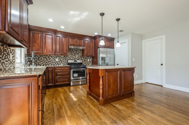 413 Robyn Pl, East Meadow, NY 11554 - kitchen with stainless steel appliances, under cabinet range hood, dark wood-type flooring, decorative backsplash, and recessed lighting