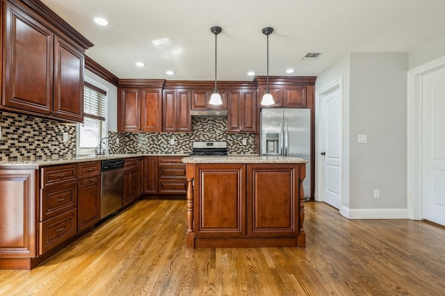 413 Robyn Pl, East Meadow, NY 11554 - kitchen with stainless steel appliances, light wood-style flooring, under cabinet range hood, decorative backsplash, and recessed lighting
