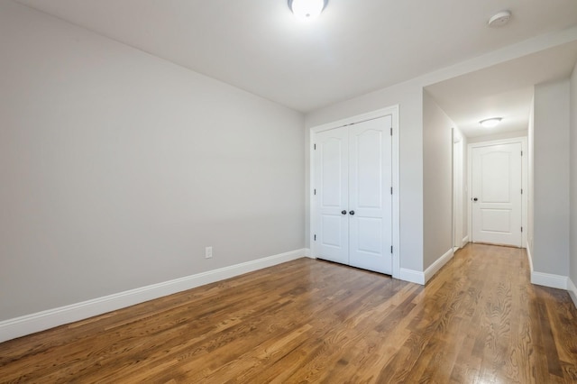 413 Robyn Pl, East Meadow, NY 11554 - unfurnished bedroom with wood finished floors and a closet