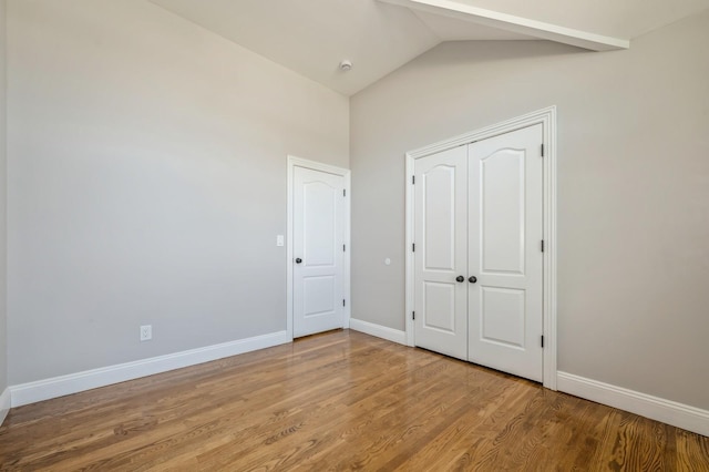 413 Robyn Pl, East Meadow, NY 11554 - unfurnished bedroom featuring wood finished floors, vaulted ceiling, and a closet