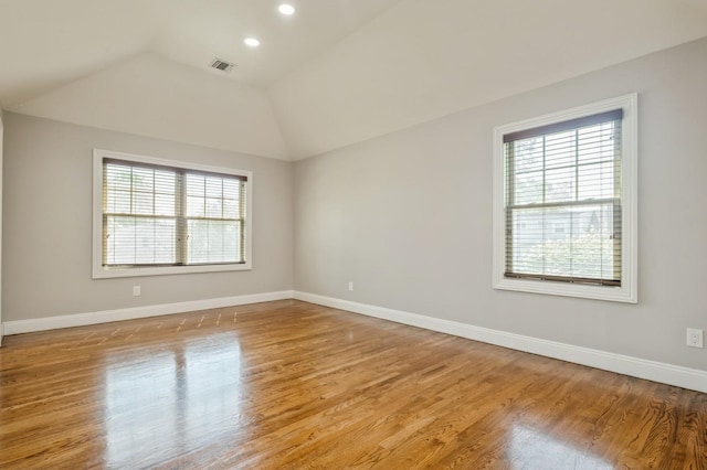 413 Robyn Pl, East Meadow, NY 11554 - spare room featuring healthy amount of natural light, lofted ceiling, wood finished floors, and recessed lighting