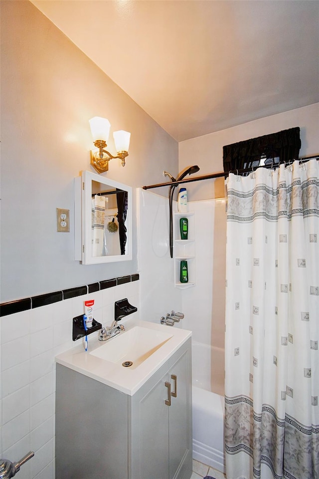 770 Bronx River Rd Unit A53, Bronxville, NY 10708 - bathroom featuring vanity, shower / tub combo with curtain, secured water heater, and tile walls