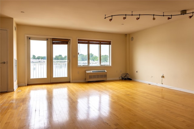 600 Clarence Ave Unit 2H, Bronx, NY 10465 - unfurnished room featuring light wood finished floors and a wall mounted air conditioner
