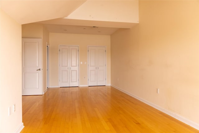 600 Clarence Ave Unit 2H, Bronx, NY 10465 - unfurnished bedroom with multiple closets and light wood-type flooring