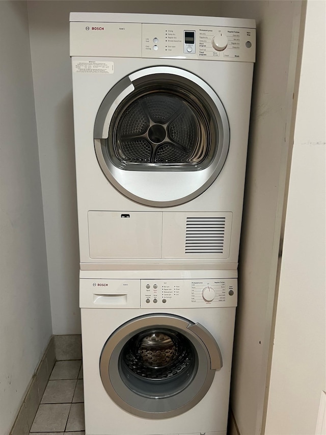 600 Clarence Ave Unit 2H, Bronx, NY 10465 - laundry room featuring stacked washer and clothes dryer and light tile patterned flooring