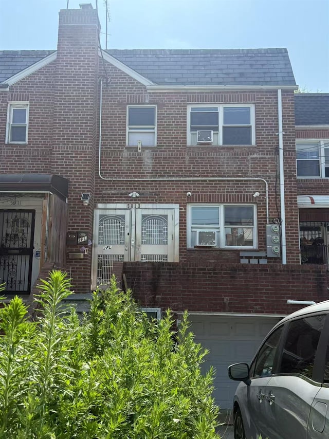 58-13 150th St, Flushing, NY 11355 - townhome / multi-family property featuring brick siding and a garage