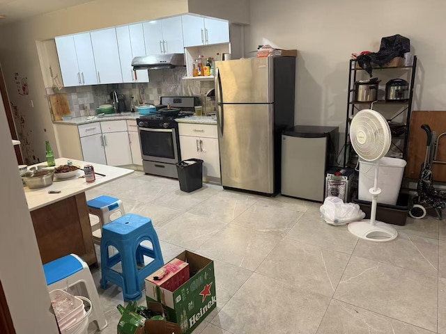 58-13 150th St, Flushing, NY 11355 - kitchen featuring stainless steel appliances, under cabinet range hood, light countertops, decorative backsplash, and white cabinets