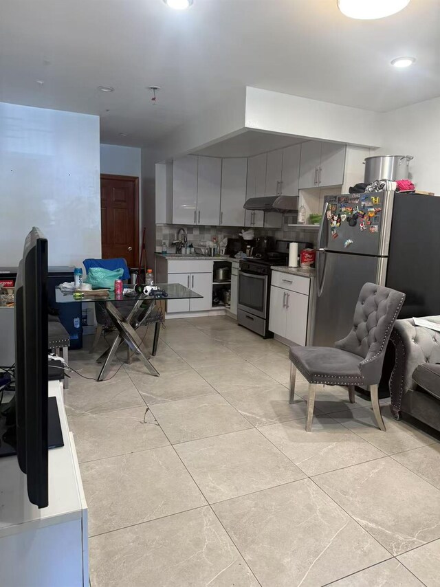 58-13 150th St, Flushing, NY 11355 - kitchen with appliances with stainless steel finishes, under cabinet range hood, decorative backsplash, gray cabinetry, and light tile patterned flooring