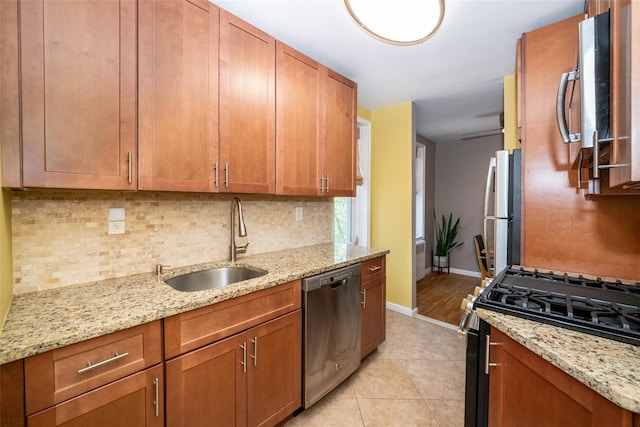 625 Gramatan Ave Unit 6L, Fleetwood, NY 10552 - kitchen with stainless steel appliances, tasteful backsplash, brown cabinetry, and light stone counters
