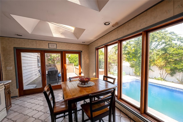 805 Arlington Rd, West Babylon, NY 11704 - dining area featuring a skylight, healthy amount of natural light, and wallpapered walls