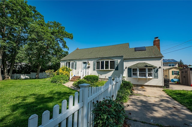 805 Arlington Rd, West Babylon, NY 11704 - view of front facade with a fenced front yard, a chimney, a storage unit, and roof with shingles