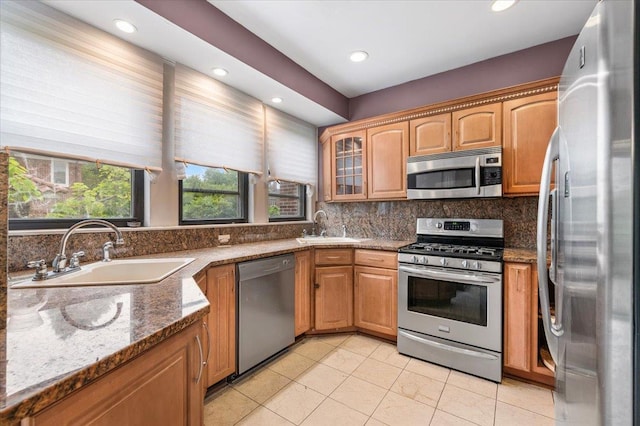 345 Broadway, Lawrence, NY 11559 - kitchen with appliances with stainless steel finishes, tasteful backsplash, stone counters, recessed lighting, and light tile patterned floors