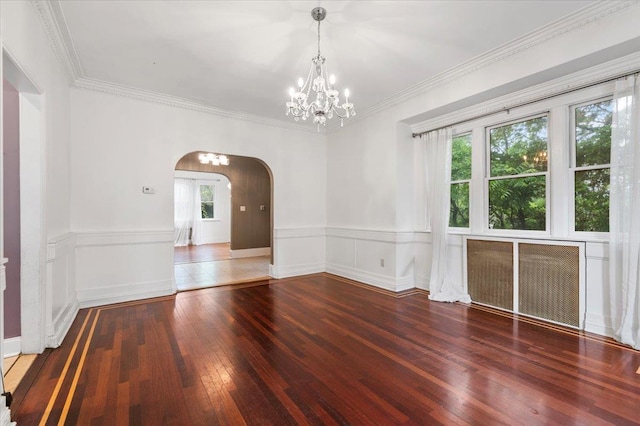 345 Broadway, Lawrence, NY 11559 - spare room featuring arched walkways, wood-type flooring, wainscoting, crown molding, and a chandelier