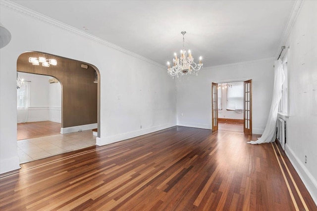 345 Broadway, Lawrence, NY 11559 - spare room featuring arched walkways, wood finished floors, ornamental molding, a chandelier, and healthy amount of natural light