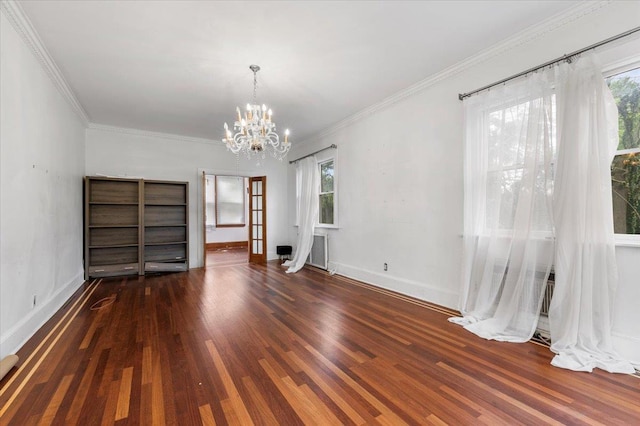 345 Broadway, Lawrence, NY 11559 - spare room featuring a chandelier, plenty of natural light, wood finished floors, and crown molding