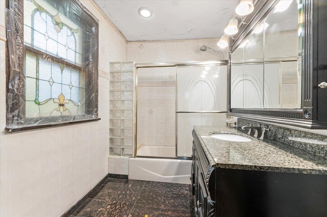 345 Broadway, Lawrence, NY 11559 - full bathroom featuring vanity, combined bath / shower with glass door, and tile walls