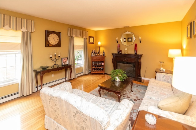 25 Briarwood Dr, Wappingers Falls, NY 12590 - living area with wood finished floors, a glass covered fireplace, and baseboard heating